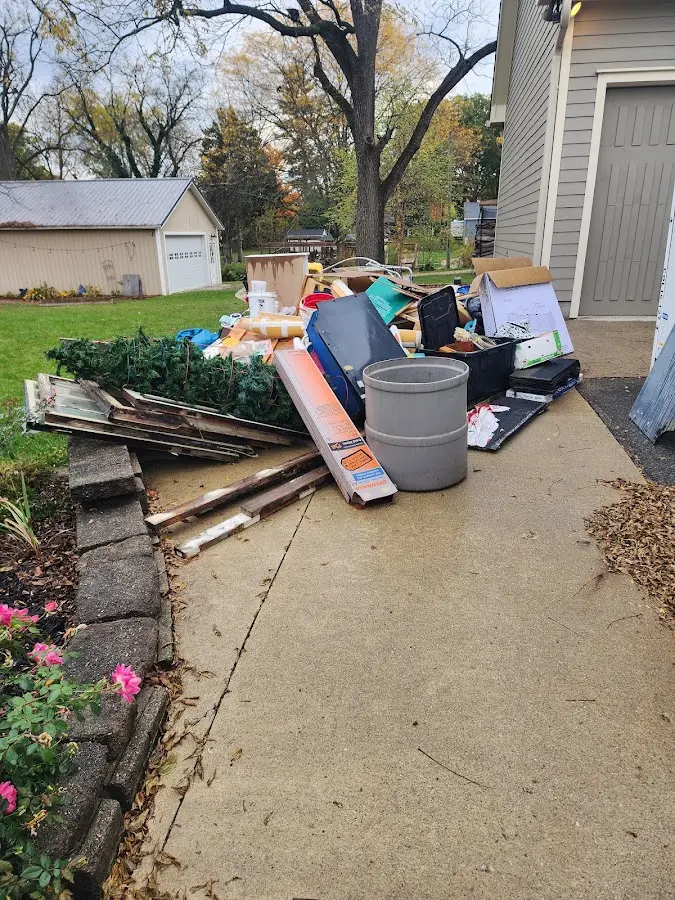 Dumpster being loaded with debris for 12 Yard Dumpster Rental in Montebello